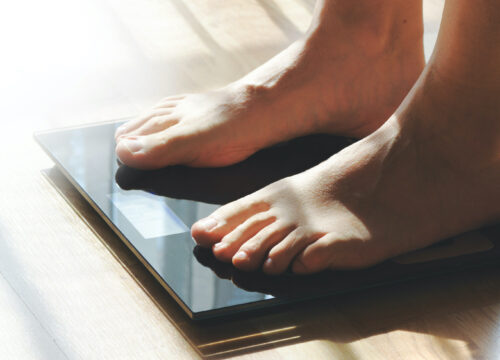 Photo of a person's feet standing on a scale